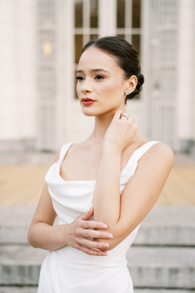 Close-up bridal portrait with elegant makeup and a sleek gown outside the Boathouse in Prospect Park, captured by Lexie Vaccaro Photography.