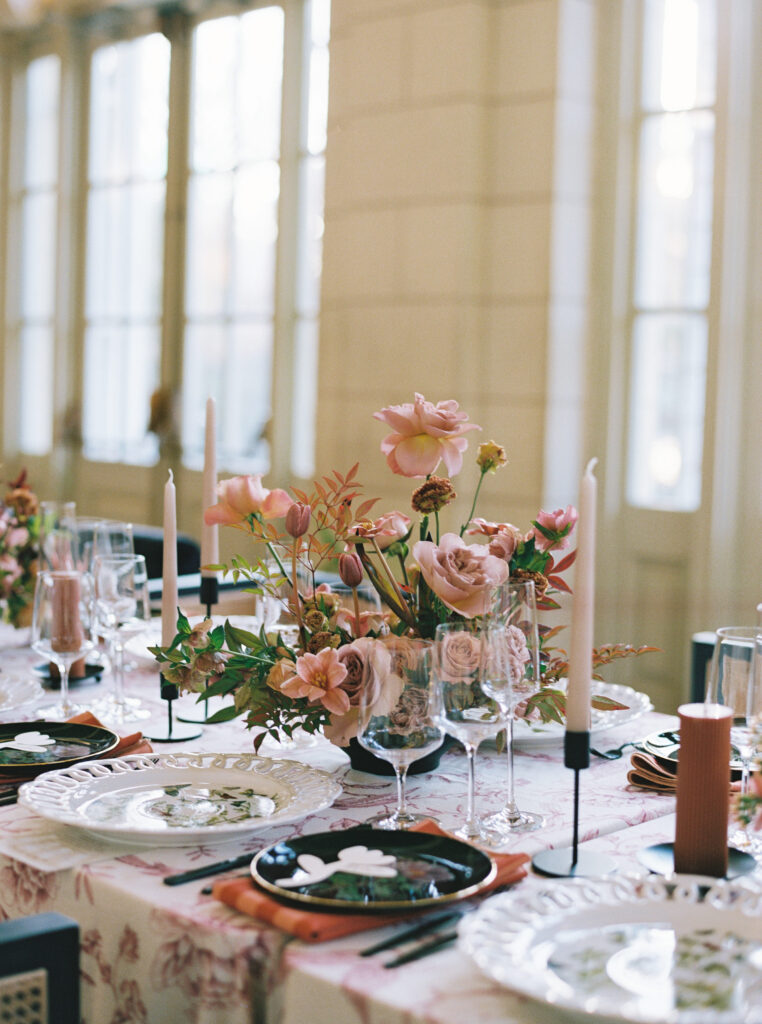 Elegant wedding tablescape with blush florals, black candlesticks, and layered modern place settings at Purslane at the Boathouse in Prospect Park