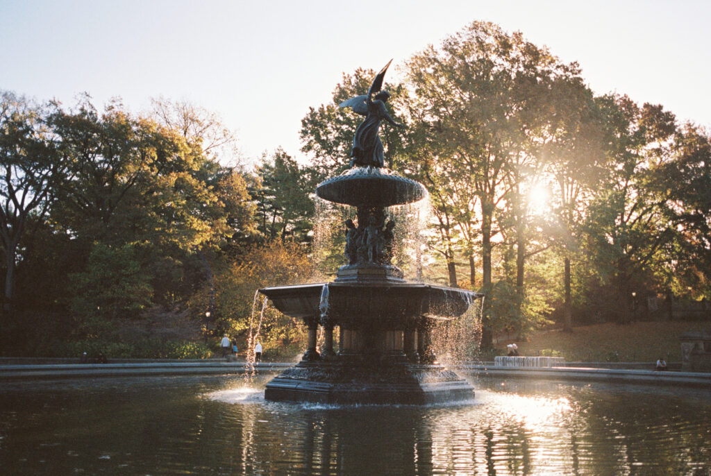 Bethesda Fountain in Central Park, New York City, photographed on film by Lexie Vaccaro Photography with golden sunlight streaming through the trees.